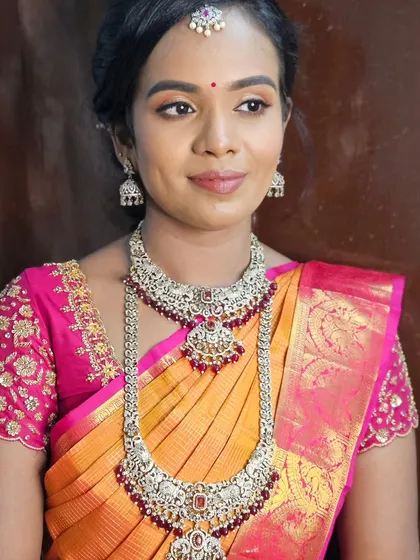 This bride is wearing beautiful silver temple jewelry with ruby accents, so we paired it with a soft pink lip and defined eyes for a cohesive look.