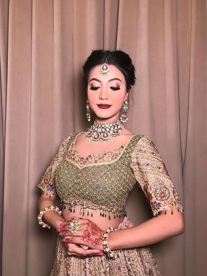 A close-up of the model wearing the "JW Madhu" set, showcasing the intricate details and the beautiful color combination.