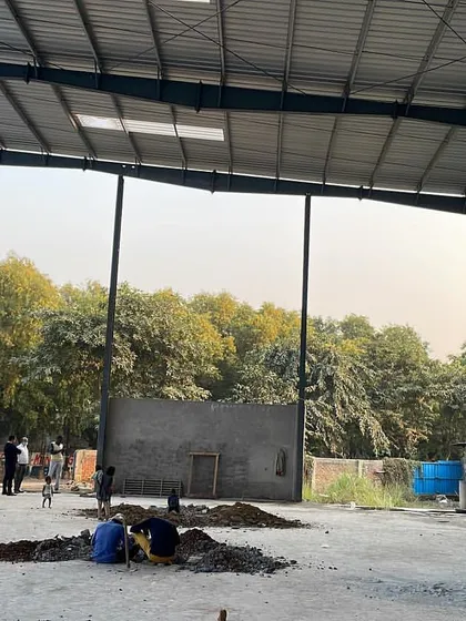 This is the interior of a pre-engineered building (PEB) structure during the construction phase. We specialize in planning and erecting these large-span steel structures for factories, workshops, and warehouses, ensuring a robust and efficient framework for any industrial operation.