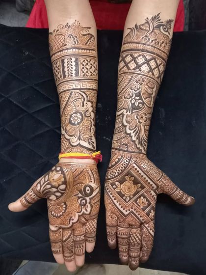 Full-hand mehandi with lighter, more spaced-out patterns. This design gives good coverage while still feeling elegant and not as dense as bridal mehandi.