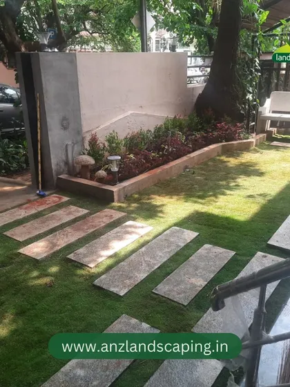 The view from the side showcases the stone bench and mature trees we incorporated into the garden design, creating a shady and relaxing corner.