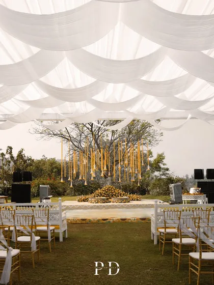 The full view of the sunflower-themed Haldi setup. A canopy of white drapes contrasts beautifully with the bright yellow floral decor, creating an elegant and cheerful atmosphere.