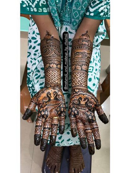 This bridal design features beautiful peacock figures on the palms and architectural dome motifs on the arms. The dark stain from my organic henna paste is already starting to show.