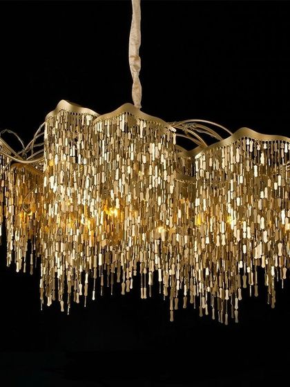 This chandelier makes a bold statement with its cascading antique gold chains. The layers of chains create a fluid, waterfall-like effect that beautifully diffuses the light, adding texture, warmth, and a touch of vintage glamour to your interior.