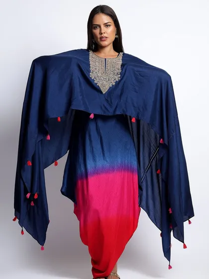 The front view of the dhoti and cape set, highlighting the embellished neckline and dramatic silhouette.