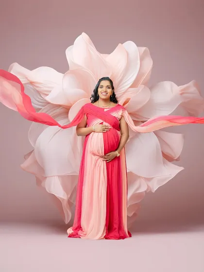Here, I used a two-toned pink gown and flowing sashes to create a sense of movement and grace. The large floral backdrop complements the colors, resulting in a vibrant and joyful maternity photo.