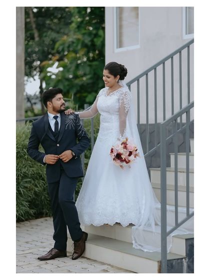 A formal couple portrait on the steps, showing the bride and groom looking at each other. This is a timeless shot that every couple will cherish in their wedding album.