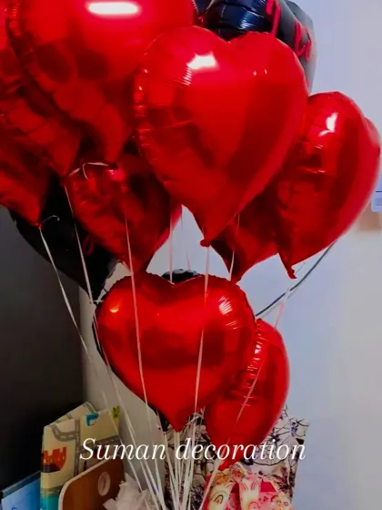 A close-up of the red and black heart-shaped balloon bouquet.