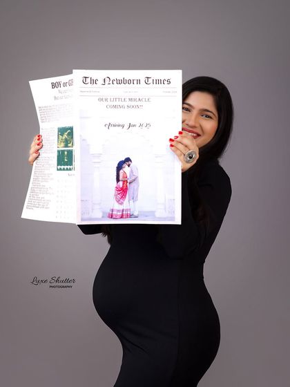 The big reveal! A joyful follow-up to the previous shot, this portrait captures the mother-to-be's happy smile as she shares the news from her "Newborn Times" paper.