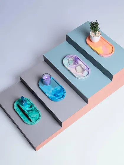 I also create smaller decor objects to bring color and personality to your home. This set of handcrafted concrete trinket trays shows how I play with marbling and color to make each piece unique. They are perfect for organizing small items or just adding a pop of color.