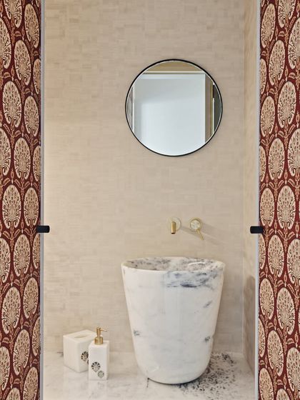 For this powder room in the Maximum City Duplex, we used a bold, traditional Indian block-print wallpaper, paired with a sculptural, freestanding marble sink to create a memorable design statement.