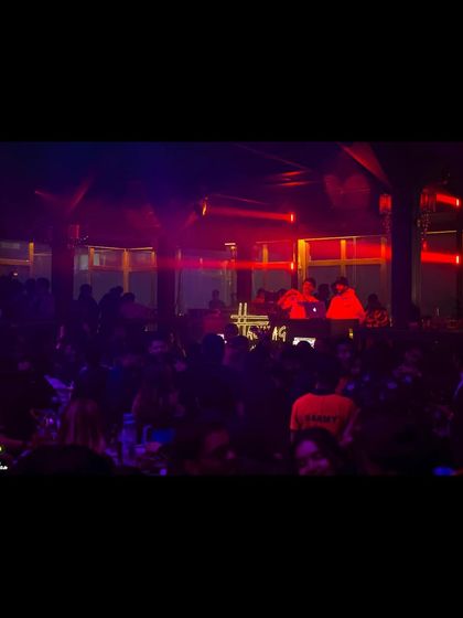 A darker, more intimate shot of the DJ booth and crowd at Hashtag in Kolkata.