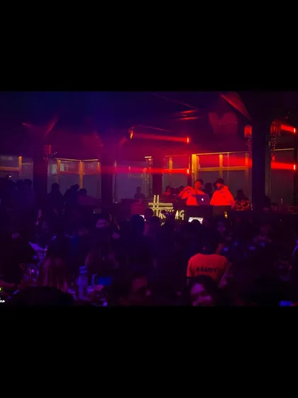 A darker, more intimate shot of the DJ booth and crowd at Hashtag in Kolkata.