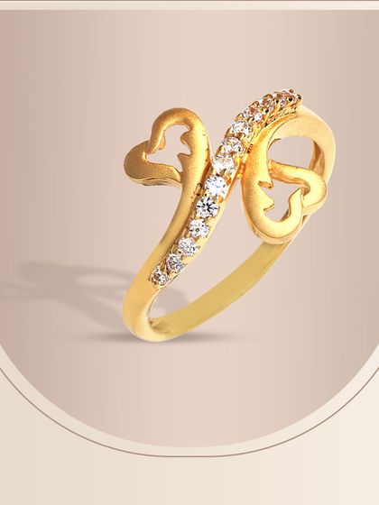 This gold ring showcases a unique design with two hearts and a graceful swirl of diamonds. It’s a modern and artistic expression of love, crafted with our signature attention to detail.