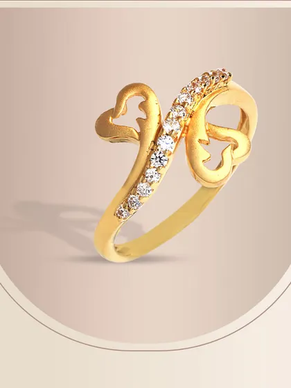 This gold ring showcases a unique design with two hearts and a graceful swirl of diamonds. It’s a modern and artistic expression of love, crafted with our signature attention to detail.