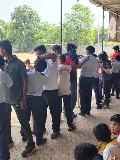 Students getting their first experience of holding and aiming a rifle under the close supervision of my coaching team. This image captures the excitement and curiosity of learning a new skill.