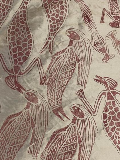 This is the story of a Yawkyawk (young woman mermaid) design by artist Janet Marawarr. Her original lino tile is being carefully translated into a woodblock by our carvers, preserving the story for our collaborative textile collection.