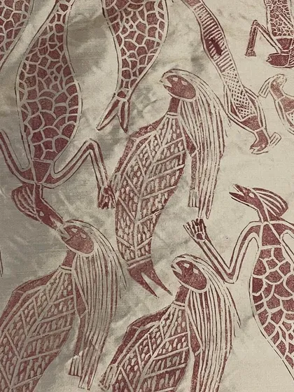 This is the story of a Yawkyawk (young woman mermaid) design by artist Janet Marawarr. Her original lino tile is being carefully translated into a woodblock by our carvers, preserving the story for our collaborative textile collection.