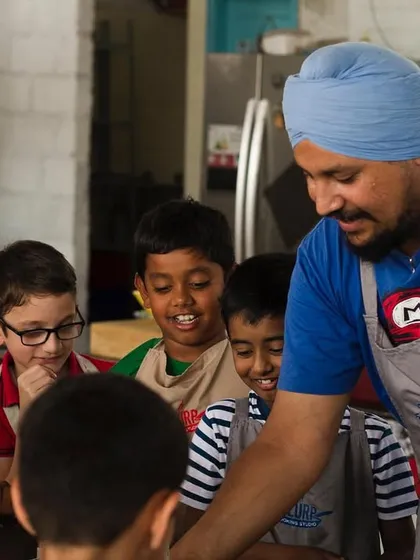 Our chef sharing his passion for cooking with the next generation. These moments of connection and learning are what we cherish most.
