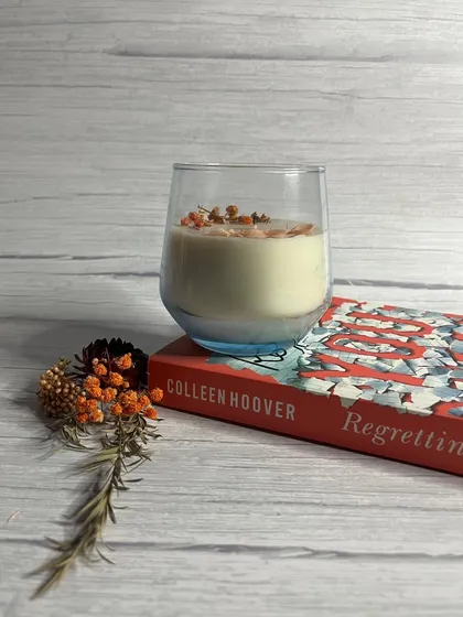 Our Luxè glass candle, decorated with dried flowers. It's a beautiful, aesthetic candle perfect for gifting or for your own home.