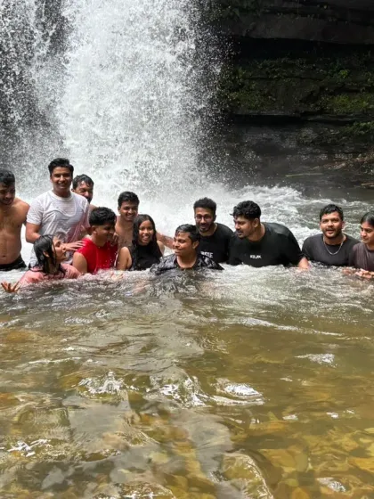 A candid group photo in the water, capturing the smiles and camaraderie of the Nethravathi trekking batch.