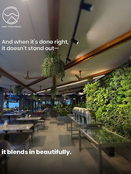 A vertical garden in a restaurant setting. When biophilic design is done right, it does not stand out; it blends in beautifully, creating an atmosphere that feels naturally calming and upscale.