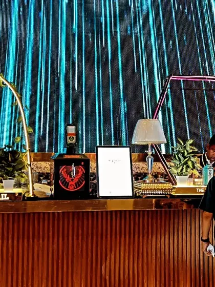 I can match any theme, from rustic to modern. This setup features a sleek, wood-paneled bar with a massive LED screen backdrop, creating a high-end, contemporary feel for a wedding cocktail event.