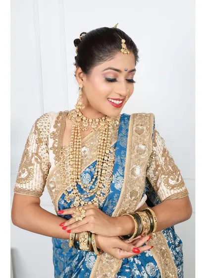 A happy portrait in the royal blue brocade Nauvari, paired with a cream embroidered blouse.