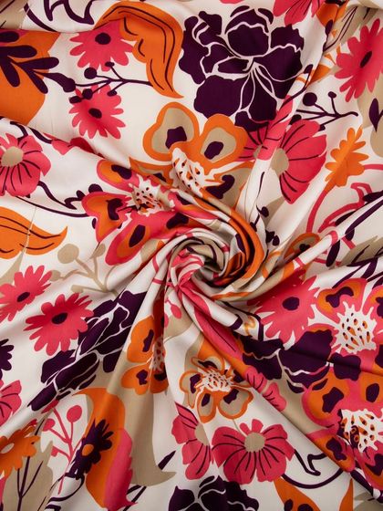 The floral fabric swirled to show its drape, texture, and sheen.