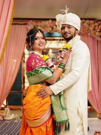 A classic portrait of the wedding couple. Her radiant makeup complements his traditional attire beautifully.