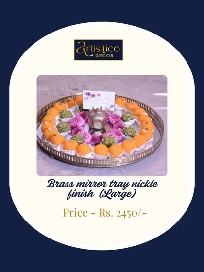 A large brass mirror tray in a nickel finish, shown here beautifully arranged with laddoos. The combination of the mirror and metal creates a festive and luxurious feel.