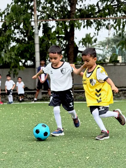 Two of our youngest players compete for the ball in a practice match, learning the basics of tackling and defending in a fun, supportive setting.