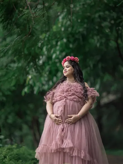 A beautiful, soft-lit portrait in a dusty rose gown. The texture of the gown and the natural background create a romantic feel.