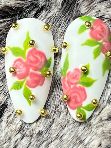 A beautiful floral design with 3D rose art and gold bead accents. This is a great example of romantic, textured nail art.