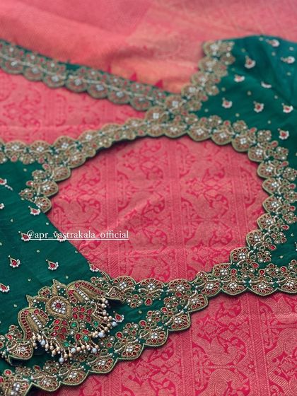 The back of the green blouse, featuring an intricate cutout design.