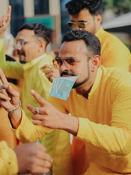 The energy of the groom's side during the Haldi celebrations. This candid shot captures the fun and playful antics of the guests as they dance and celebrate.