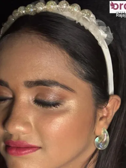 A close-up of the dewy makeup, highlighting the radiant skin and shimmering highlighter.