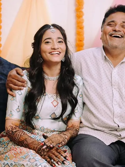 A father's joyful laugh is one of the most precious things to capture on a wedding day. This candid moment between the bride and her dad is priceless.