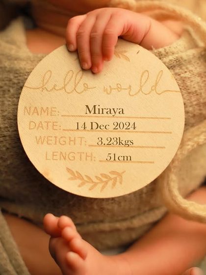 A detail shot focusing on the personalized wooden plaque announcing baby Miraya's name, birth date, weight, and length. This is a wonderful way to commemorate these important statistics.