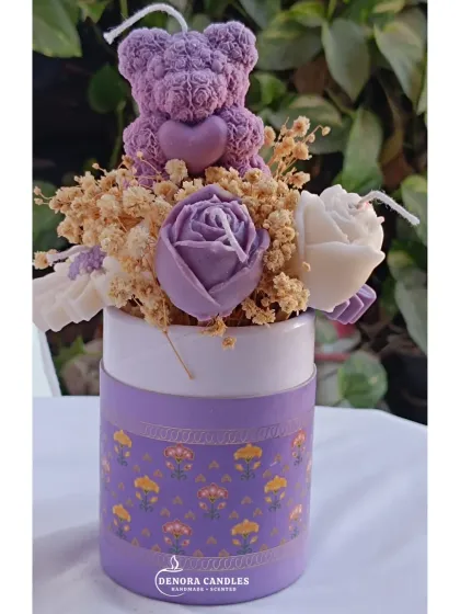 The purple flower bouquet candle, showing my brand logo on the box.