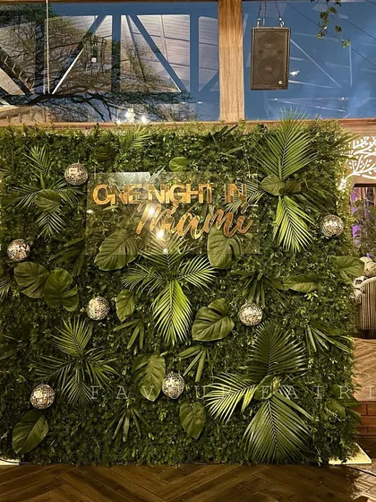 "One Night in Miami" was the theme for this fun stag party. We created a dense wall of tropical foliage, a custom neon sign, and scattered disco balls for a cool, club-like vibe.