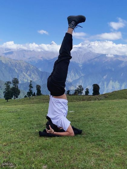 Finding my balance with Shirshasana (Headstand) in the mountains of Uttarakhand. Practicing inversions in nature adds a profound sense of connection and grounding.