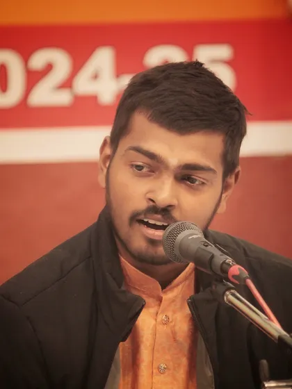 A young student presenting his piece at the 'Swarveni Aradhana'. His focused expression shows his deep involvement in the music.