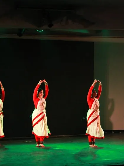 A synchronized group formation from 'Mix & Match'. The dancers are wearing the iconic white and red-bordered sarees of Bengal, used here to create a sense of unity and grace.