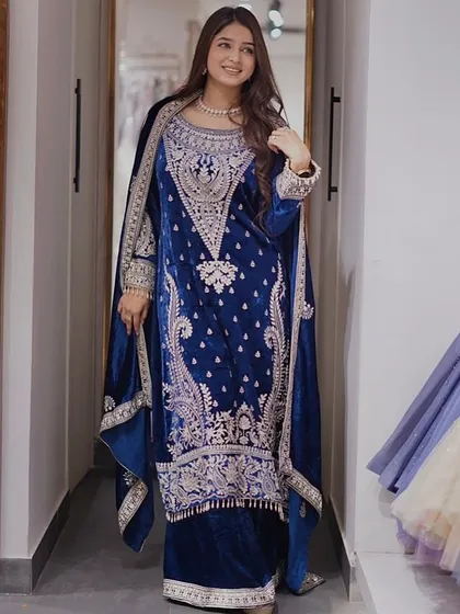 Who says you can't be warm and look fabulous? This royal blue velvet suit is my answer to winter weddings. The rich fabric and detailed silver embroidery give you a regal look while keeping you cozy.