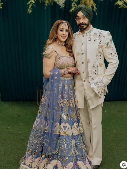This client looks regal in a custom ivory bandhgala jacket, featuring unique embroidery of elephants and traditional motifs. It's a beautiful example of how we can weave personal stories and heritage into a garment.