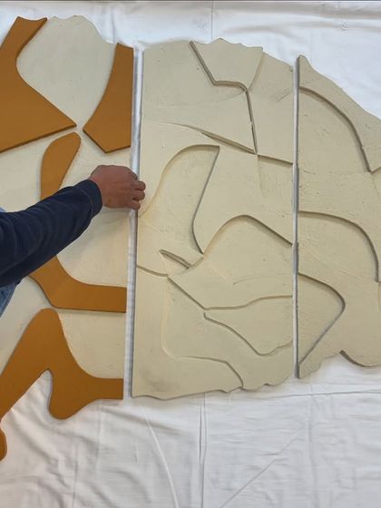 Here you can see the process of fitting the panels together. I design them to interlock seamlessly, creating a single, unified wall sculpture.