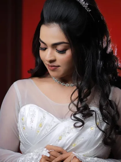 A model looking down gracefully, showcasing the beautiful eye makeup for a Christian wedding look.