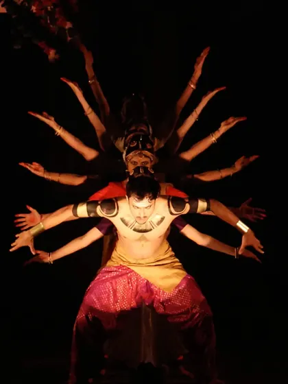A visually striking formation from "UNMASKED," a production that reinterprets the epic Ramayana. This scene depicts the multi-headed form of Ravana through a powerful arrangement of dancers.