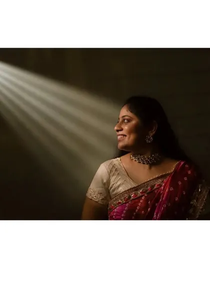 I love to play with light to create artistic and memorable portraits. Here, a simple ray of light beautifully highlights the bride's happy expression, creating a quiet, soulful image that feels both dramatic and intimate. This is a part of my creative portrait service.